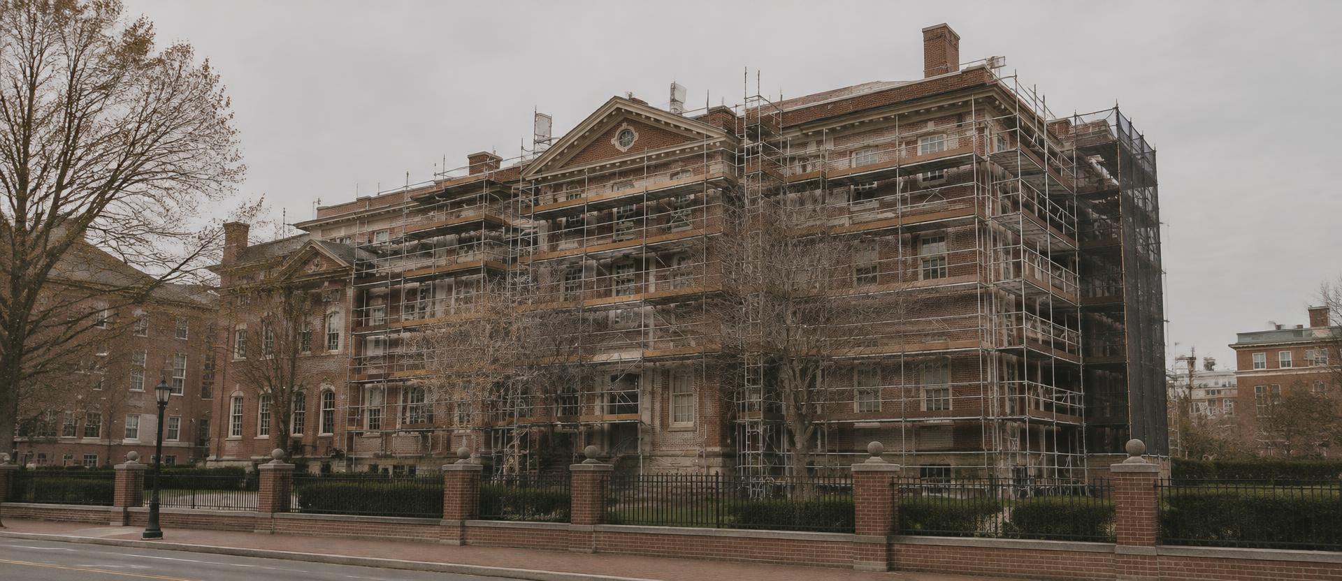 Masonry restoration scaffolding across a large brick institutional building